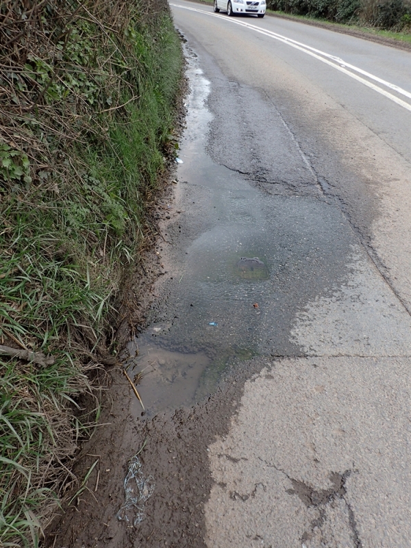 Water leaking onto road and road collapsing